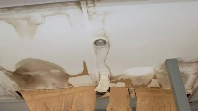 Sagging water-stained ceiling around a light fixture
