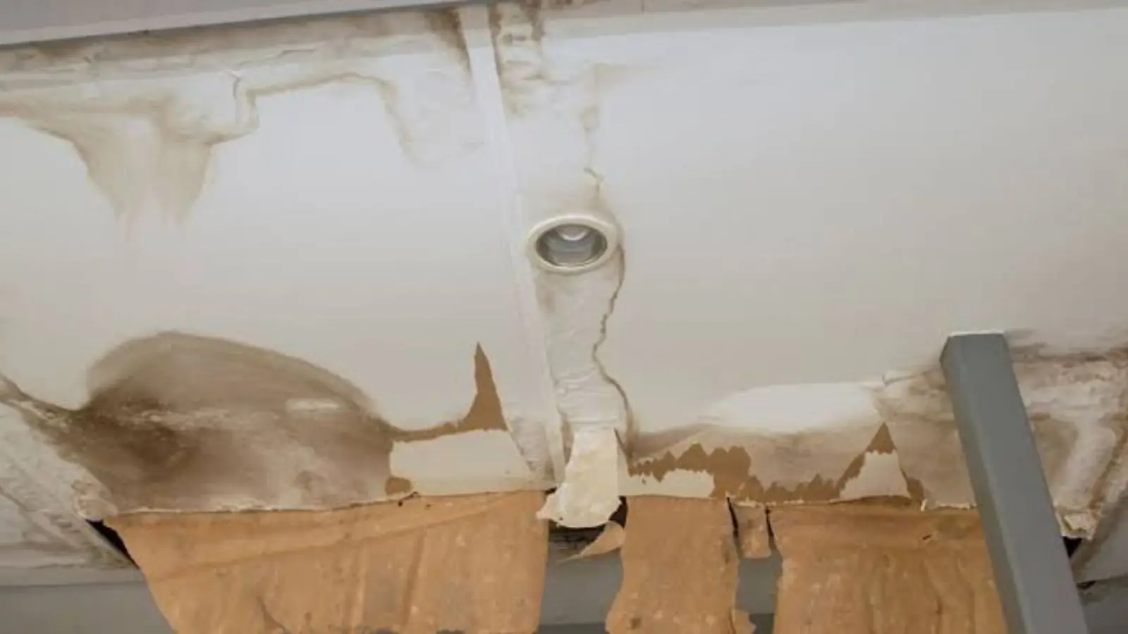Sagging water-stained ceiling around a light fixture